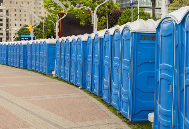 a row of portable restrooms set up for a large athletic event, allowing participants and spectators to easily take care of their needs in Dudleyville